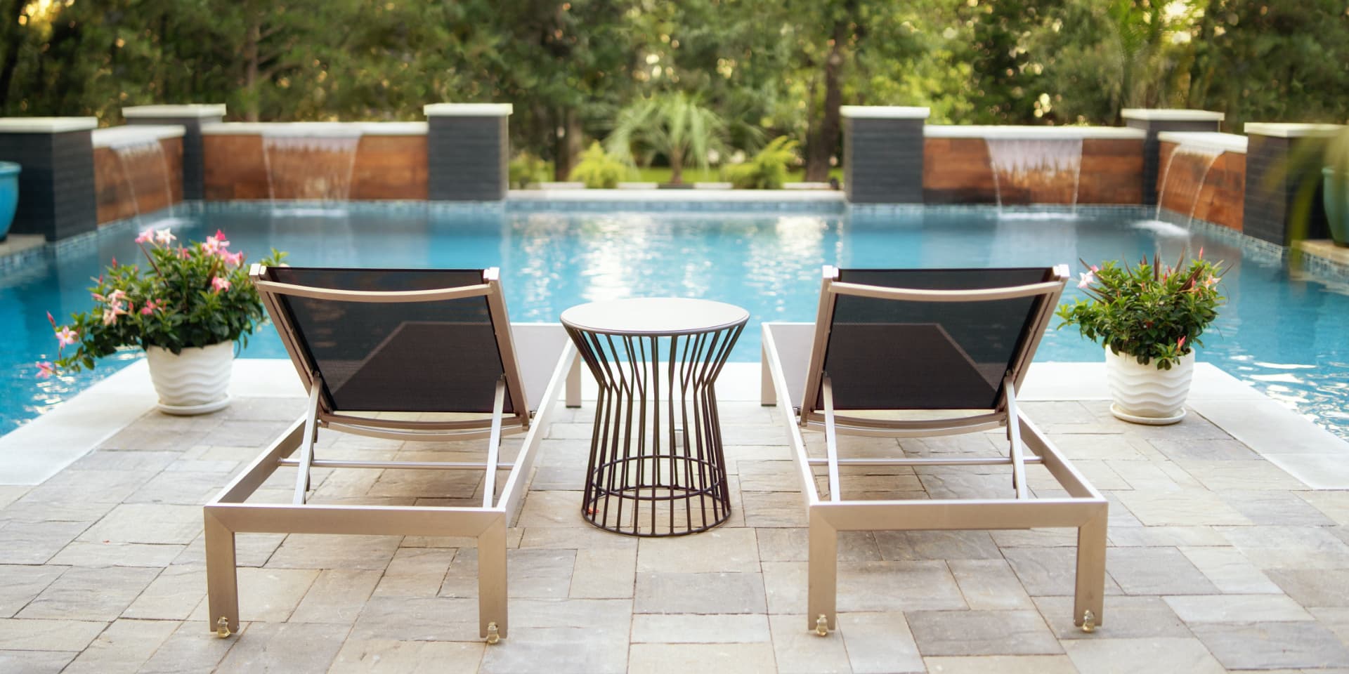 Poolside loungers with water wall features