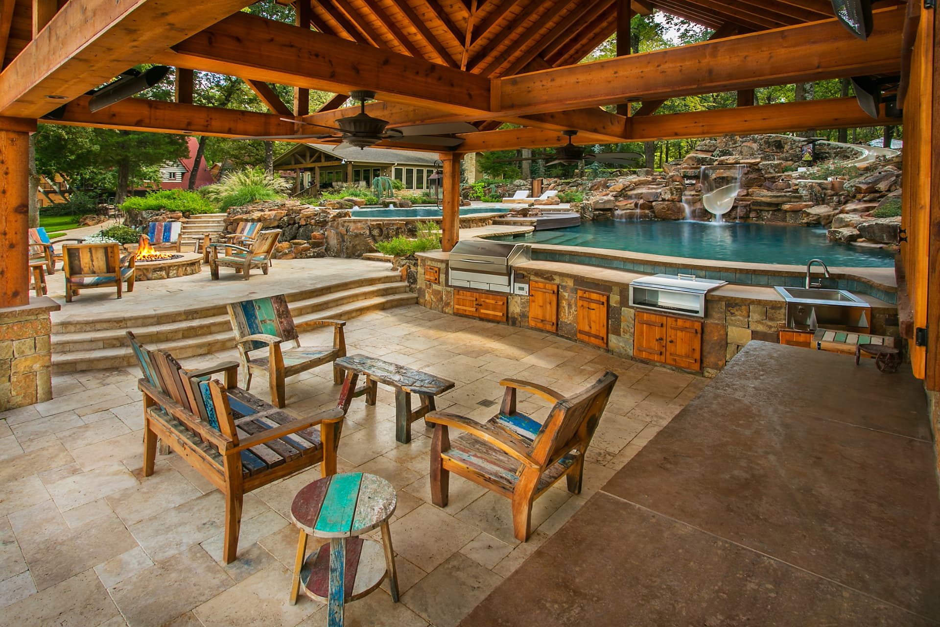 Timber-framed cabana with outdoor kitchen overlooking the pool