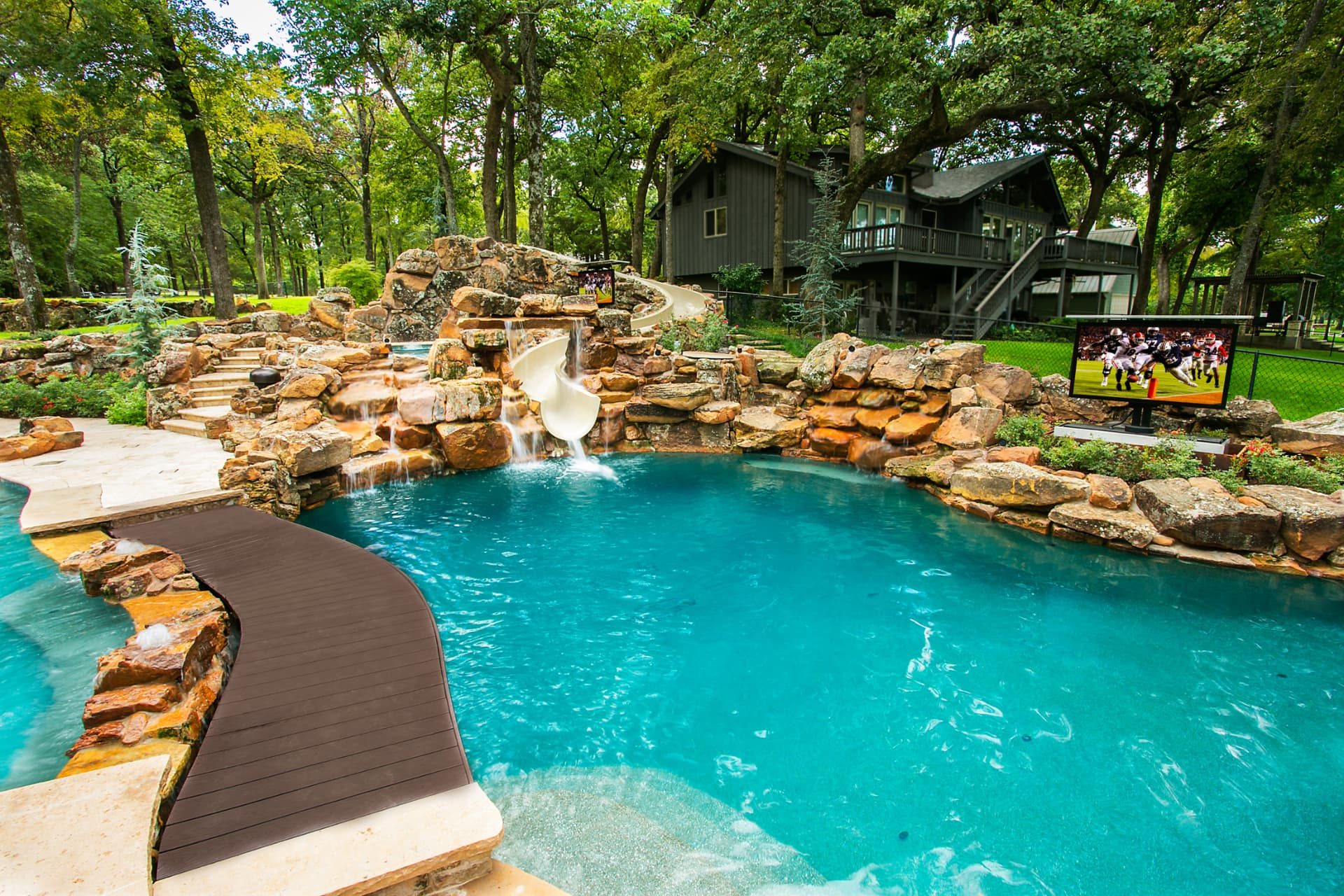 Grotto waterfall, 32-foot slide and play pool with outdoor television