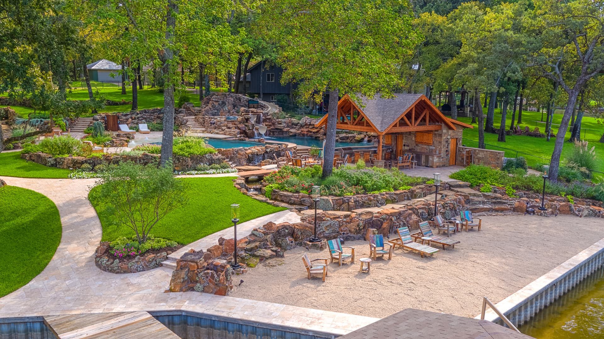 Elevated view of the pool, cabana and Mexican beach sand lounge at the lake's edge