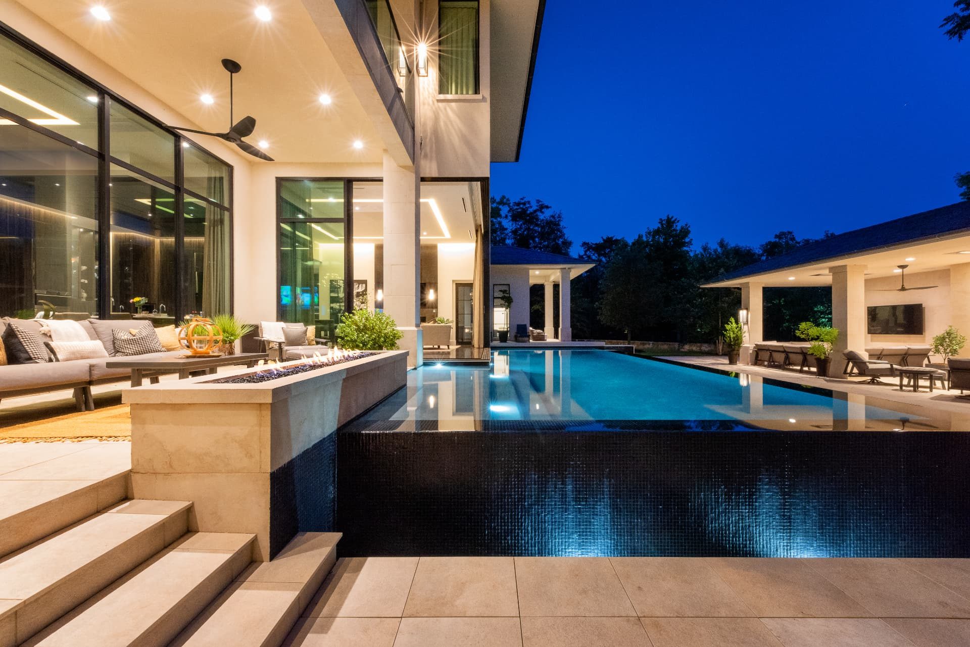 Fire feature and lounge terrace beside the straight-line pool